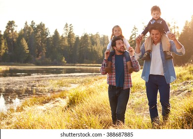Gay Male Couple With Children Walking By Lake