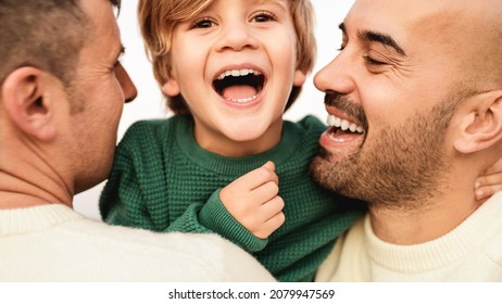 Gay Male Couple Having Tender Moment With Boy Outdoor - LGBT Family Love Concept