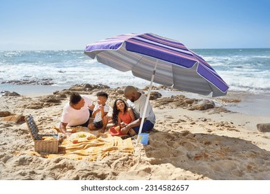 Gay male couple and kids eating picnic lunch under umbrella on sunny ocean beach, enjoying summer getaway - Powered by Shutterstock