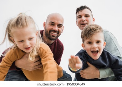 Gay Male Couple And Little Sons Having Fun Outdoors During Summer Vacation - Lgbt And Love Family Concept - Main Focus On Right Father Face