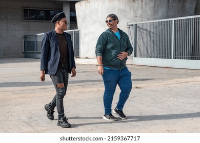 Gay Male Couple Talking While Walking Outdoors