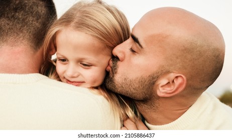 Gay Male Fathers Kissing Kid Son Outdoor - LGBT Family Having Fun - Love Concept