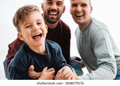 Gay Male Parents Having Fun With Their Son Outdoor - Focus On Kid Boy Face