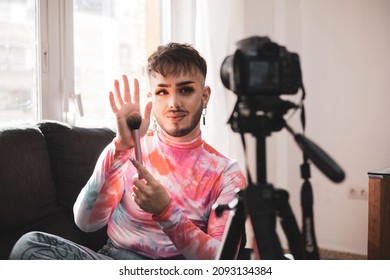 Gay Man Showing Makeup Brush On Social Media Live Video Feed With Video Camera. Lifestyle And Fashion Concept.