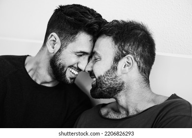 Gay men couple having tender moment together at home - Soft focus on left man eye - Black and white editing - Powered by Shutterstock