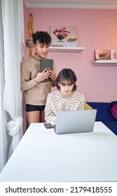 Gay Multiethnic Couple Couple Looking At Laptop