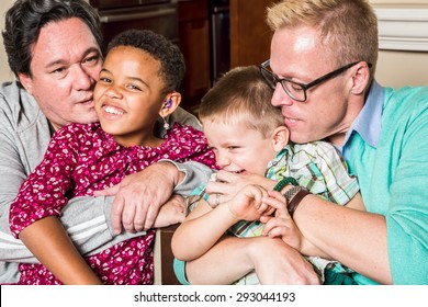 Gay Parents Kissing And Hugging Their Children 