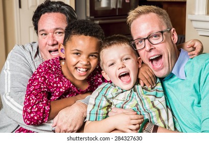 Gay Parents Pose With Their Childen In The Living Room