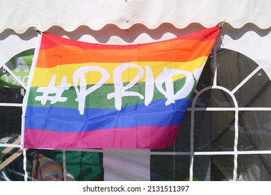 A Gay Pride Flag Hanging From The Building