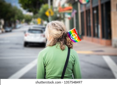 Gay Pride Flag In An Older Woman’s Hair On City Street