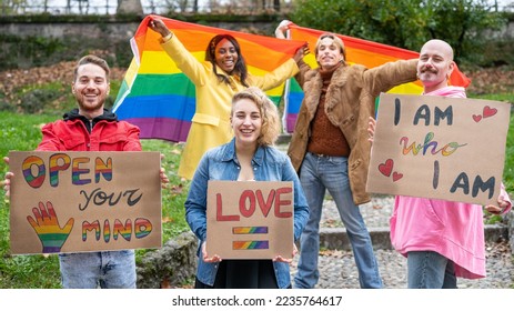 Gay Pride Parade, group of young activist for lgbt rights with rainbow flag and banner, diverse people of gay and lesbian community - Powered by Shutterstock