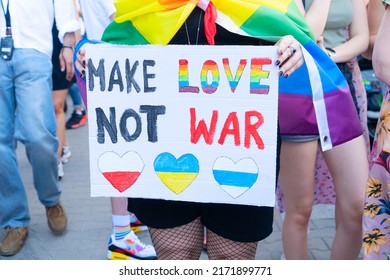 Gay pride parade, someone with make love not war poster