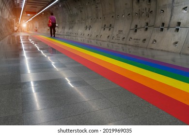 Gay pride rainbow colors or  LGBT colors is in underground tunnel.Transport walkway by Tunnel Boring Machine for infrastructure subway with raw concrete segments wall.Light at the end of the tunnel. - Powered by Shutterstock