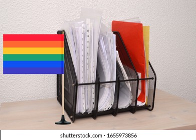 Gay Pride Rainbow Flag Next To Office Paper Organizer