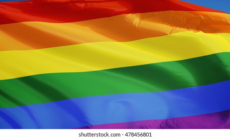 The Gay Pride Rainbow Flag Waving Against Clean Blue Sky, Close Up, Isolated With Clipping Path Mask Alpha Channel Transparency