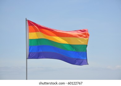 Gay Pride Rainbow Flag Waving In Sky