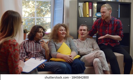 Gay And Traditional Couples Visiting Psychologist For Therapy. Four Young People Sitting In Psychologist Office Discussing Relationship Problems And Difficulties