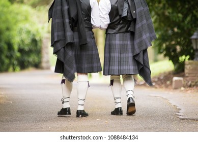 Gay Wedding Male Couple Walking Down Road, Wearing A Kilt