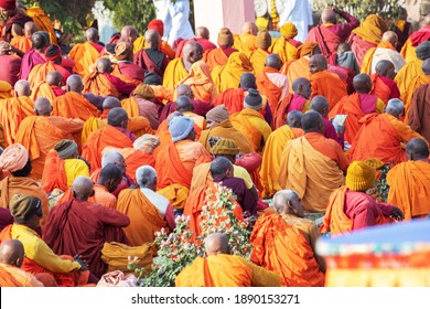 Gaya, India - January 6, 2019 :Unidentified Buddhist monks sitting on the ground of the Maha Bodhi Temple Complex .