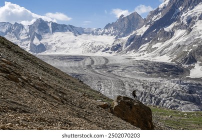 Gaze at the majestic glacier from above, its vast ice fields and crevasses shimmering under the sun. Surrounded by rugged mountains, the pristine expanse showcases nature's raw, icy beauty. - Powered by Shutterstock