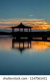 Gazebo In Lake Wat Sunset.