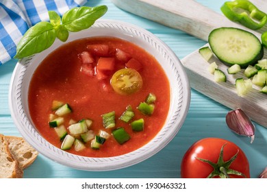 Gazpacho Andaluz is an Andalusian tomato cold soup from Spain with cucumber, garlic, pepper on light blue background - Shutterstock ID 1930463321