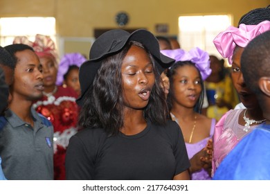 Gbagada, Lagos, Nigeria West Africa-11 July 2022: Portrait Of A Black Woman With A Hat In The Church Close Her Eyes In The Mood Of Worship And Praying 