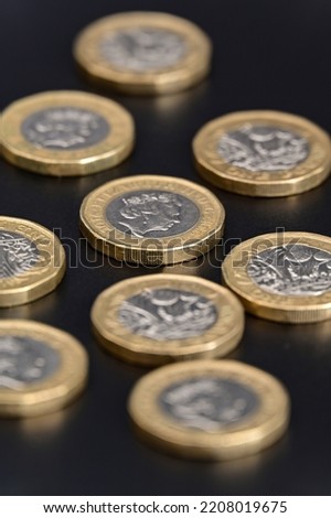 GBP British one pound coins currency on a Black background