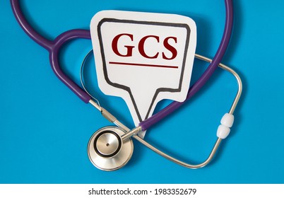 GCS (Glasgow Coma Scale) - Acronym On White Figure Sheet On A Blue Background With A Stethoscope. Medical Concept