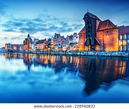 Gdansk old town and famous crane, Polish Zuraw. View from Motlawa river, Poland at romantic sunset, night. The city also known as Danzig and the city of amber.