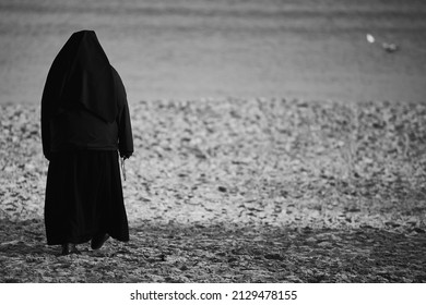 Gdansk, Poland: 26 02 2022: Religious Sister Prays At The Baltic Sea For Peace In The World