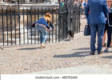 Gdansk, Poland - July 18, 2017: Women Try Catch Dog Next To Neptune's Fountain In Old Town Of Gdansk Before Arrival Of Royal Couple (Duchess Kate And Prince William).