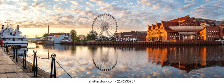 Gdansk, Poland. Panoramic view of ferris wheel and Gdansk sign at Motlawa river during sunrise. Eastern Europe travel destination at Baltic sea