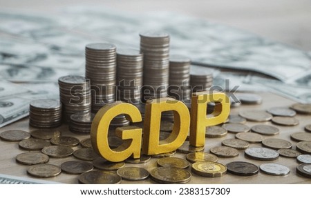GDP, Gross domestic product concept. Gold gdp text and Coins stack with a beautiful background from dollar bills. Business and GDP, good distribution practice. Copy space. [[stock_photo]] © 