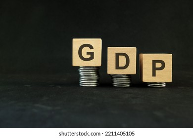 GDP Or Gross Domestic Product Fall Due Crisis Concept. Wooden Blocks In Dark Black Background.