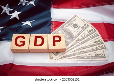 GDP or gross domestic with wooden cubes or blocks on the American flag background. Business and growth of GDP, domestic product concept. Top view - Shutterstock ID 2203502151