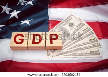 GDP or gross domestic with wooden cubes or blocks on the American flag background. Business and growth of GDP, domestic product concept. Top view [[stock_photo]] © 