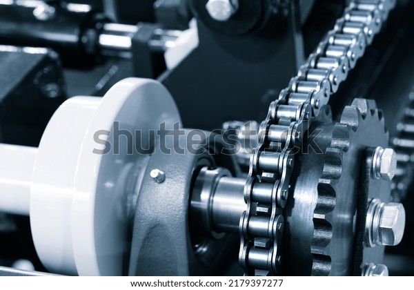 Gear\
chain drive shaft in conveyor belt is on production line. Timing\
chain of car, tensioners in engine. Industrial roller chain,\
technology. Team work, business industrial\
concept