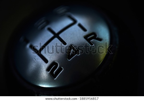 The gear lever in the car. Close-up gear shift\
knob with digital gear\
markings.