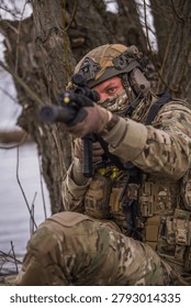 The gear is standard. The pose is practiced. But the courage it takes to hold this position — exposed, unmoving, waiting — is extraordinary.