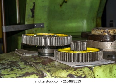 The Gear Train Of The Machine On The CNC Machine Is Lying On The Machine Waiting For Repair.