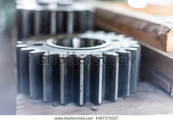 The gear wheel after milling and grinding\
processing lie on the rack.