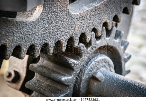 A gear wheel or pinion is a\
basic part of a gear train in the form of a disc with teeth on a\
cylindrical or conical surface meshing with the teeth of another\
gear
