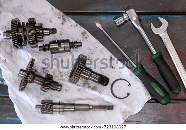 Gearbox parts on a
old wooden table with
tools