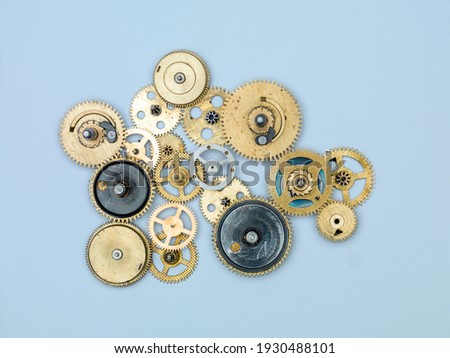 Gears and cogs macro, blue background. Top view. Vintage