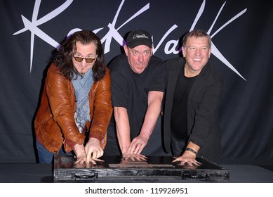 Geddy Lee, Neil Peart, Alex Lifeson At The RUSH Induction Into Guitar Center's RockWalk, Guitar Center, Los Angeles, CA 11-20-12