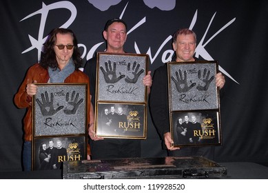 Geddy Lee, Neil Peart, Alex Lifeson At The RUSH Induction Into Guitar Center's RockWalk, Guitar Center, Los Angeles, CA 11-20-12