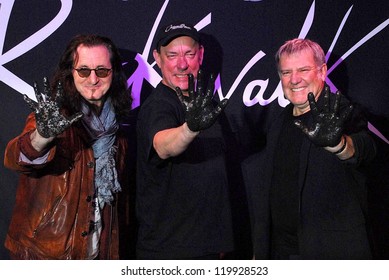 Geddy Lee, Neil Peart, Alex Lifeson At The RUSH Induction Into Guitar Center's RockWalk, Guitar Center, Los Angeles, CA 11-20-12