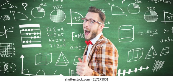 Geeky hipster pointing at camera against green chalkboard - Shutterstock ID 317173031