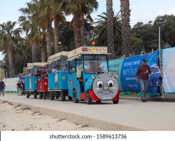 Geelong, Victoria - November 23 2019 The tourist Thomas The Tank Engine train driving along the main path at Eastern Beach. Part of the waterfront has been blocked off for the Geelong Revival event.